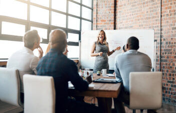 Woman, business and presentation in office for meeting with discussion, brainstorming for ideas. female manager, happiness and group for planning with teamwork, workshop for professional training